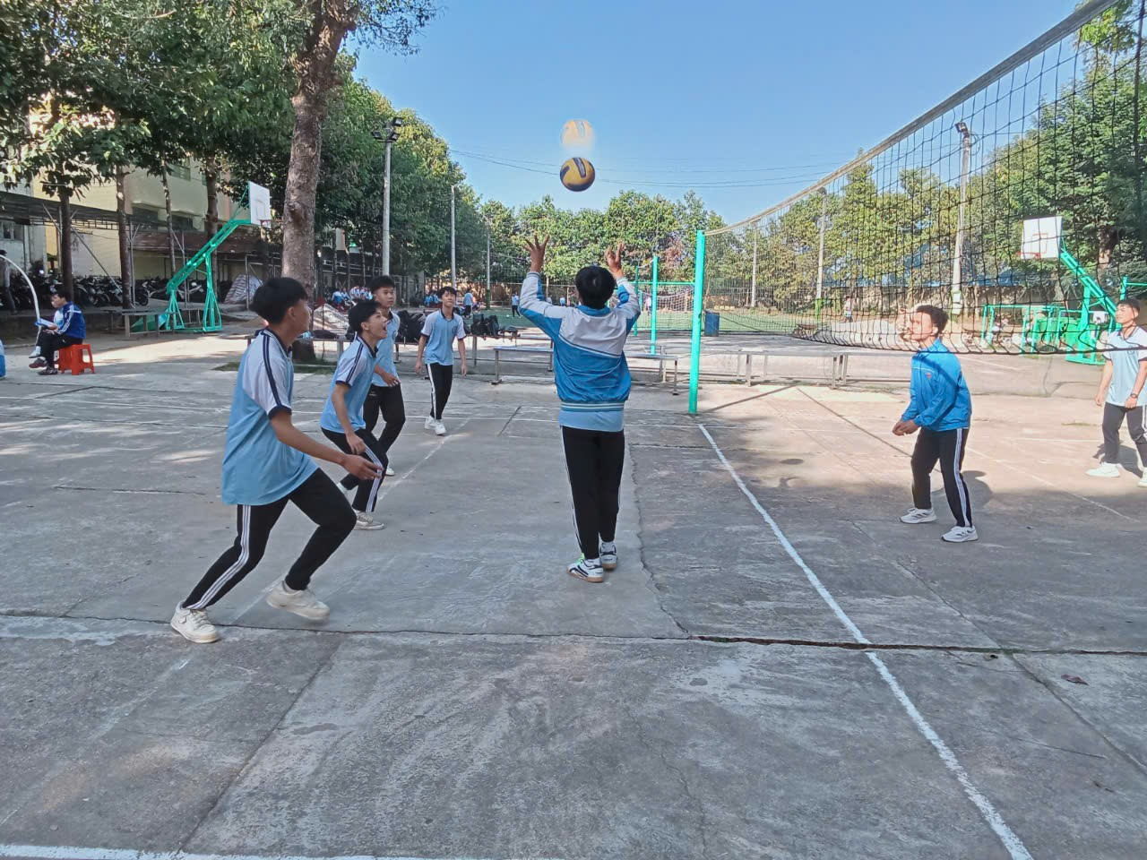 ''A group of people playing volleyball

Description automatically generated''