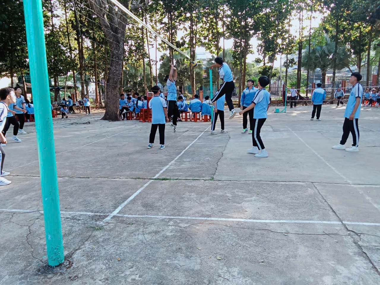 ''A group of people playing volleyball

Description automatically generated''